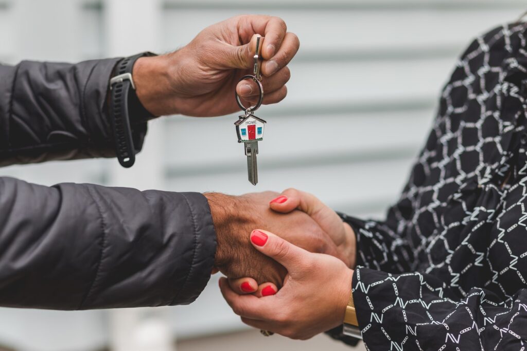 A real estate agent handing over the keys to a new homeowner