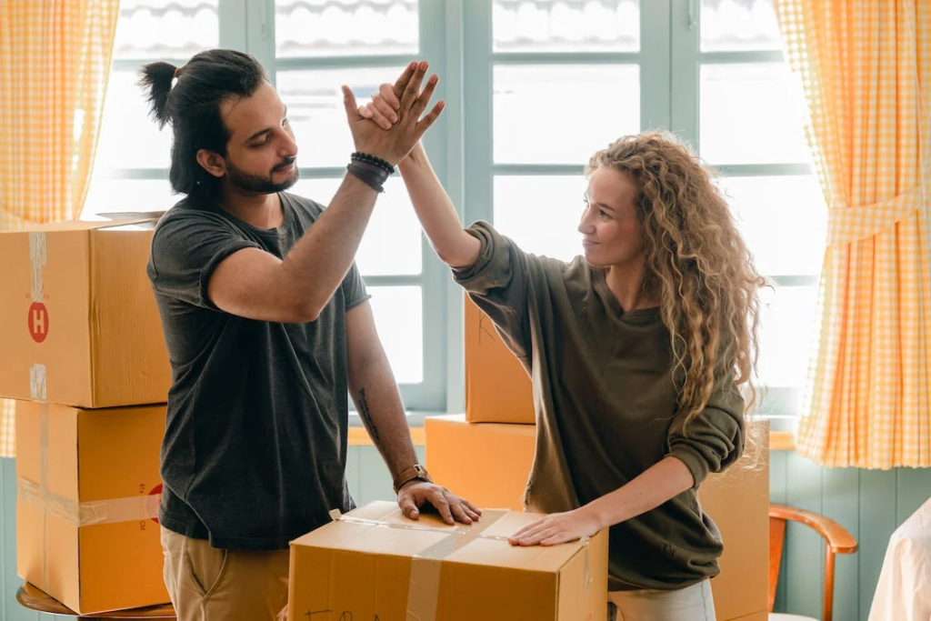Two people high-fiving after their successful out-of-state move